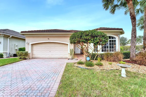 a front view of a house with a yard garage and outdoor seating