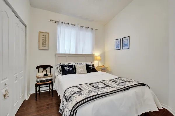 a bedroom with a bed and a chair