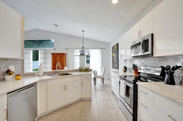 a kitchen with stainless steel appliances a sink stove and cabinets