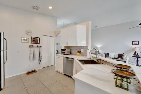 a kitchen that has a lot of cabinets a sink and appliances in it