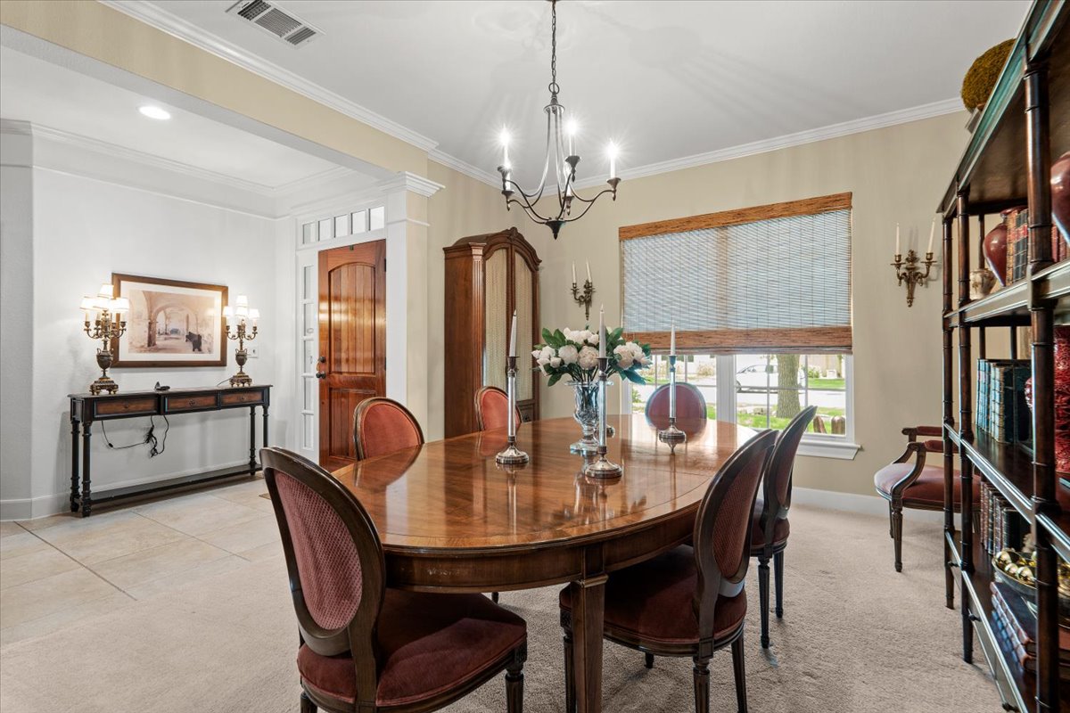503 Breezeway Lane Georgetown, TX 78633 - Photo 22 of 38 Dedicated dining room with crown molding and large windows, providing an ideal space for hosting gatherings.