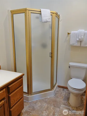 a bathroom with a shower and a toilet