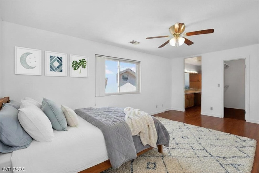 3698 Laughlin Boulevard Laughlin, NV 89029 - Photo 30 of 49 A tranquil sleeping space featuring rich hardwood floors and an adjoining vanity area for seamless morning routines.