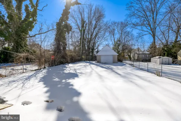 a view of a yard with snow on the road