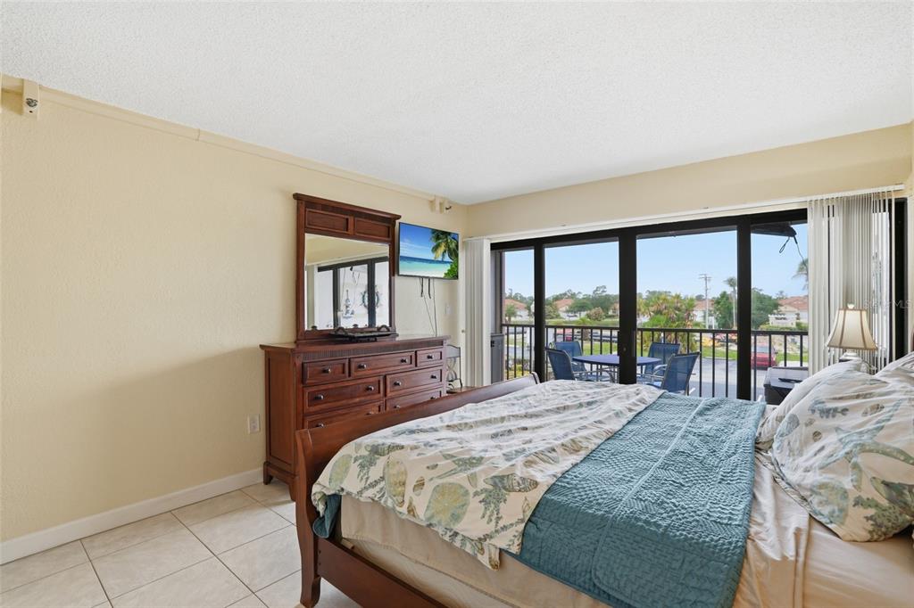 3170 Matecumbe Key Road, Unit 127 Punta Gorda, FL 33955 - Photo 11 of 22 a bedroom with a bed and a large window