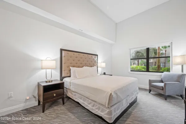 a bedroom with a bed and a couch