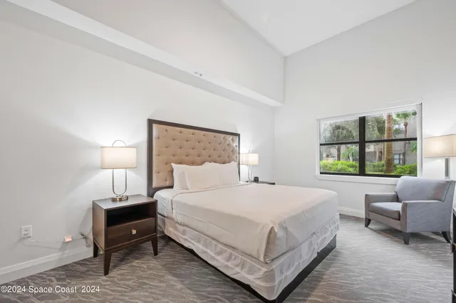 a bedroom with a bed and a couch