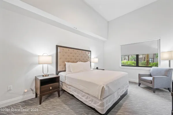a spacious bathroom with a shower sink and mirror