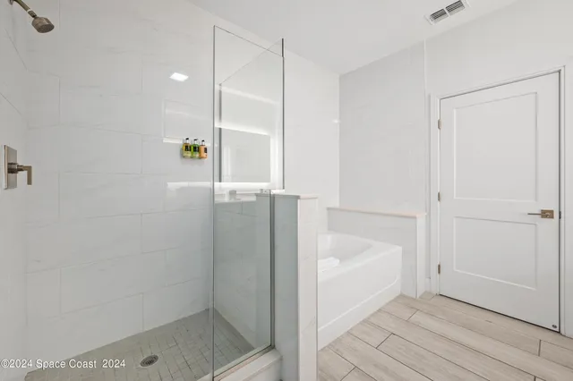 a bathroom with a bathtub and a shower