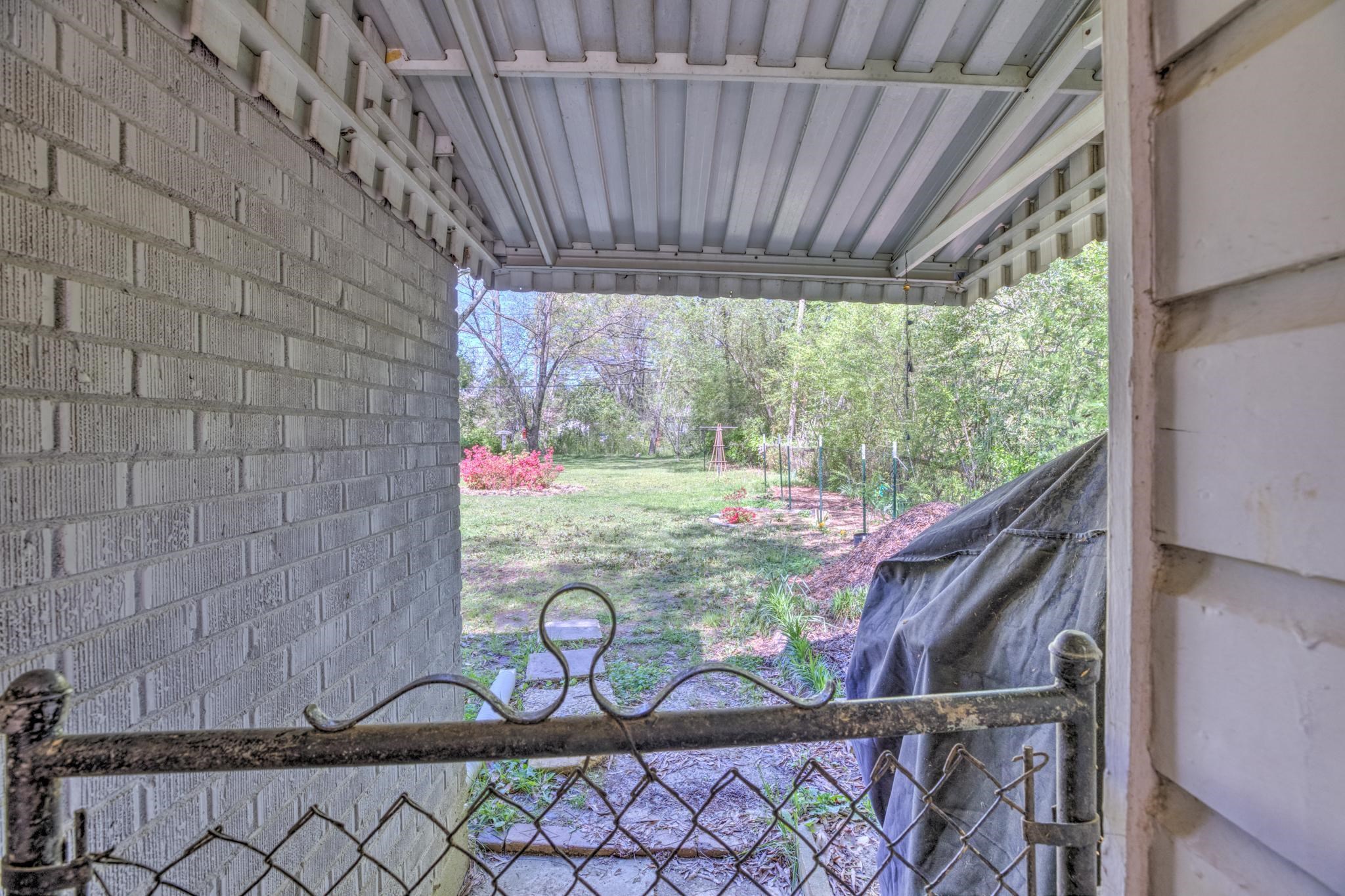 1421 Flamingo Road Memphis, TN 38117 - Photo 23 of 23 a view of a room with swing plants and wooden fence