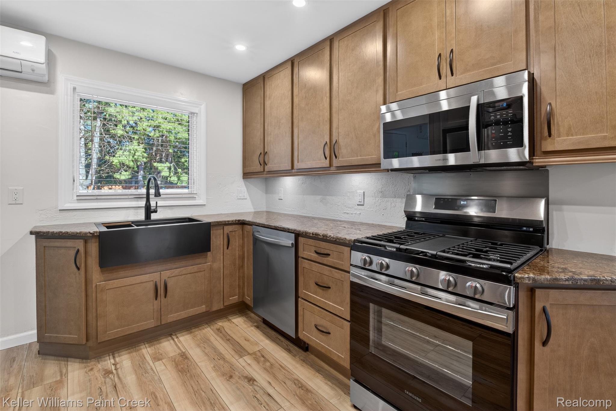 2942 Tatham Road Saginaw, MI 48601 - Photo 4 of 59 Kitchen featuring stainless steel appliances, dark stone countertops, light wood-style floors, wood finish cabinetry, and recessed lighting