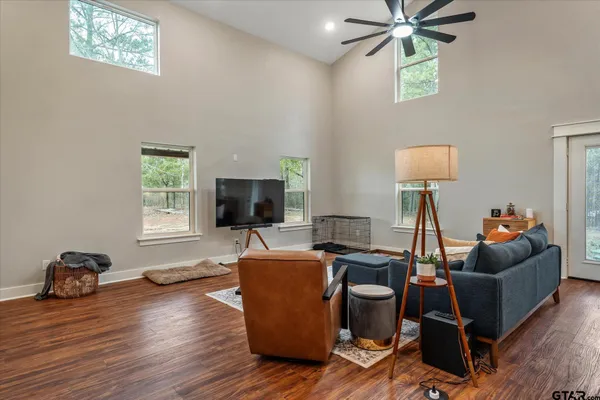 a living room with furniture kitchen view and a window