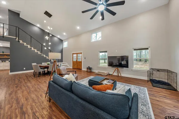 a kitchen with stainless steel appliances granite countertop a kitchen island a stove a table and a refrigerator