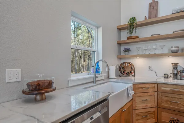 a stove top oven sitting inside of a kitchen