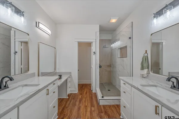 a bathroom with a shower sink and mirror