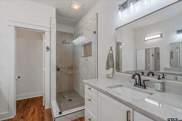 a bedroom with a large bed and a ceiling fan