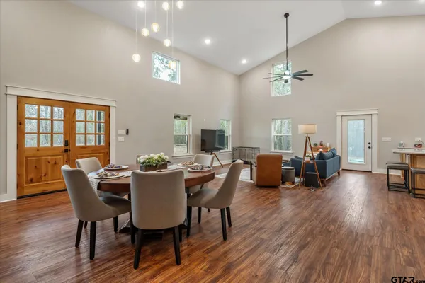 a view of a dining room with furniture wooden floor and a chandelier