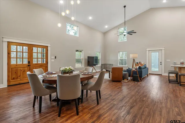 a view of a dining room with furniture wooden floor and a chandelier