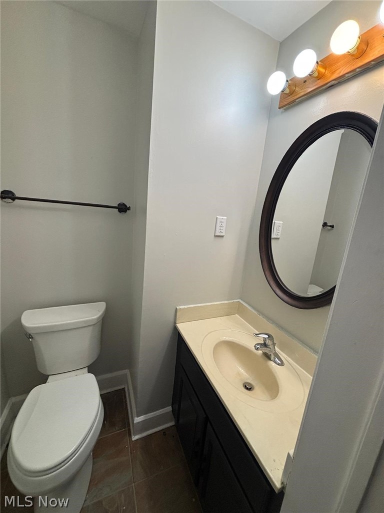 3808 Kirkwood Road Cleveland Heights, OH 44121 - Photo 6 of 6 Half bath with vanity and dark tile patterned flooring