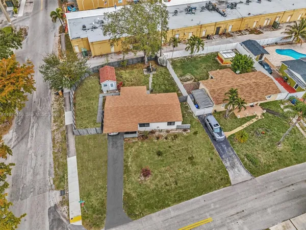 an aerial view of residential houses with outdoor space