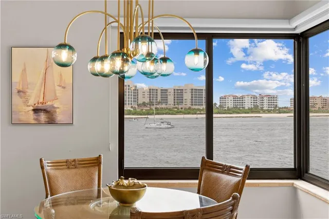 a view of a dining room with furniture and chandelier