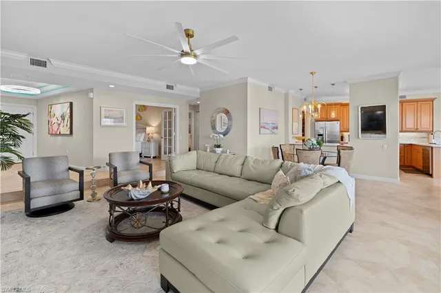 a living room with furniture and a chandelier