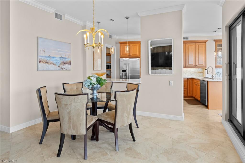 524 La Peninsula Boulevard, Unit 524 Naples, FL 34113 - Photo 13 of 44 a dining room with furniture and window
