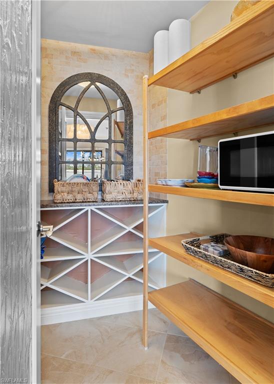 524 La Peninsula Boulevard, Unit 524 Naples, FL 34113 - Photo 20 of 44 a view of a livingroom with furniture and staircase