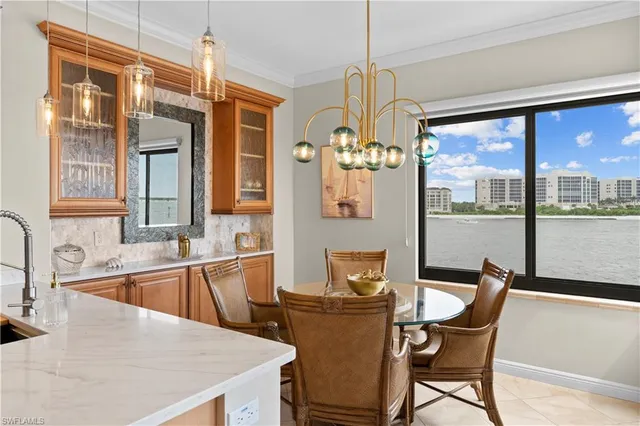 a kitchen with a table chairs and wooden floor