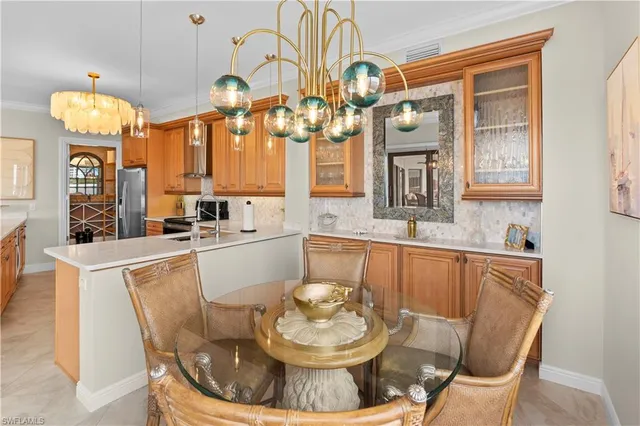a kitchen with a table and a chandelier