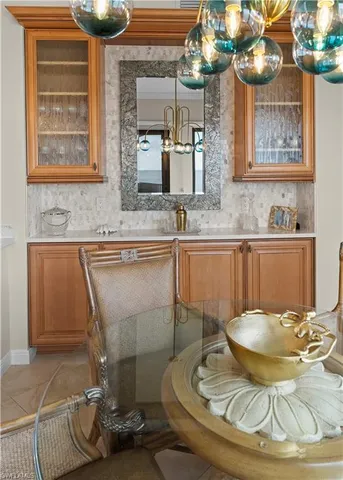 a bedroom with a bed a chair and a large window