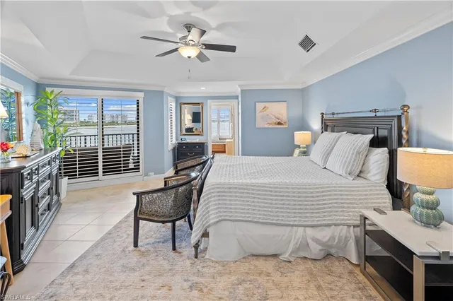 a bedroom with a bed a window and a flat screen television