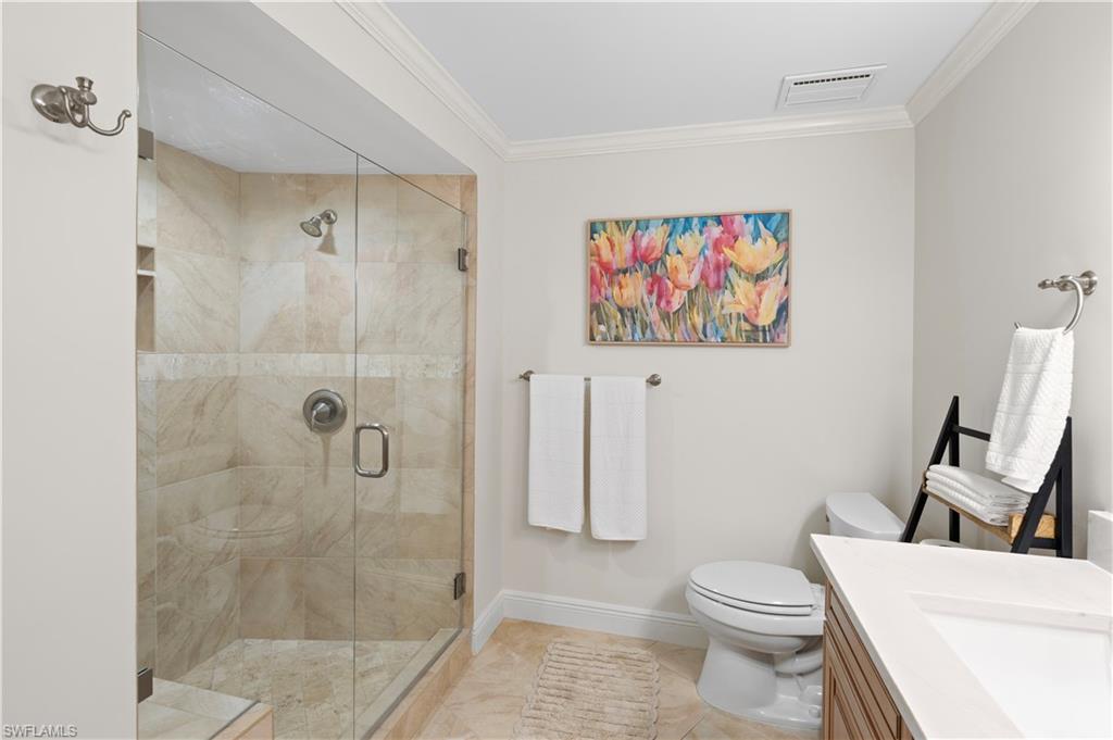 524 La Peninsula Boulevard, Unit 524 Naples, FL 34113 - Photo 36 of 44 a bathroom with a toilet and a shower