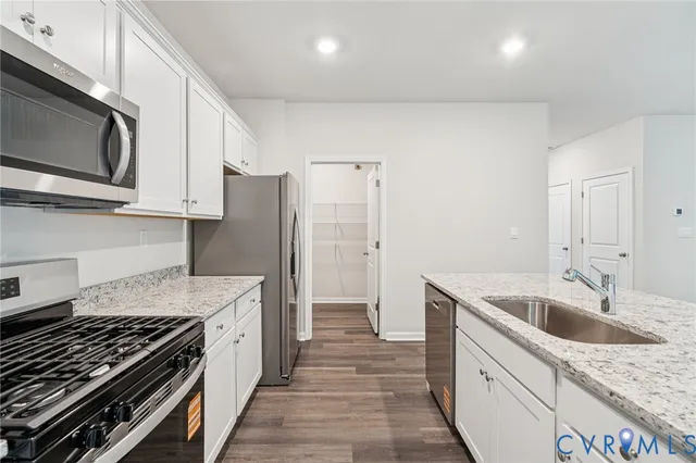 a kitchen with a sink stove and refrigerator