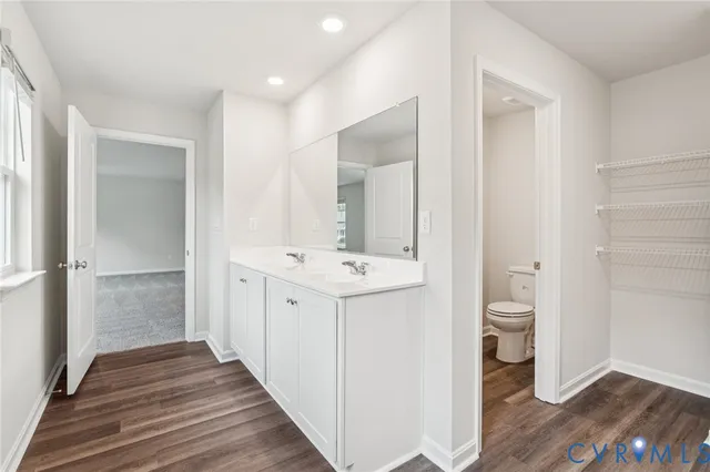 a bathroom with a sink mirror toilet and shower