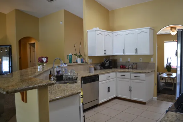 a kitchen with stainless steel appliances granite countertop a sink and cabinets