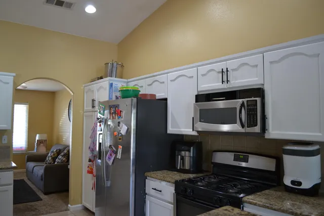 a kitchen with stainless steel appliances a refrigerator and a stove