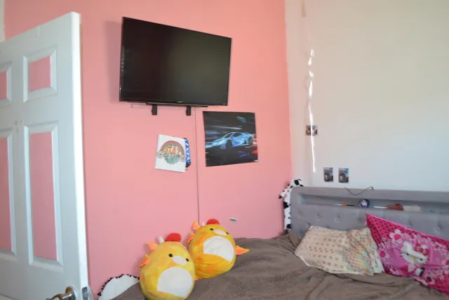 a bedroom with a bed and a window