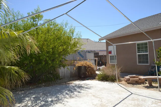 an aerial view of a house with garden space and sitting area