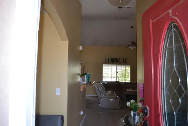 a living room with furniture a window and a flat screen tv