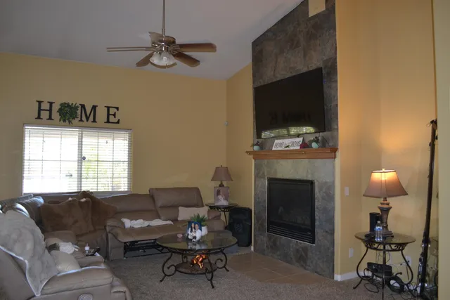 a living room with furniture a window and a flat screen tv