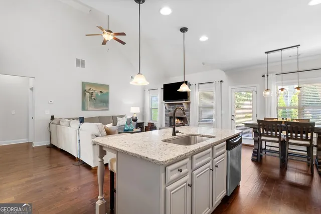 a kitchen with a stove center island with a wooden floor