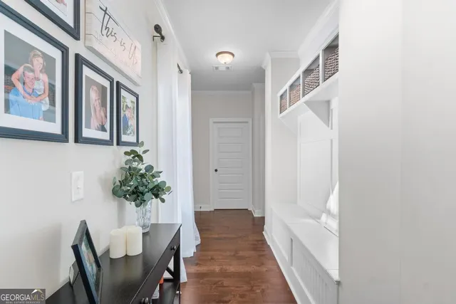 a view of a hallway with furniture and a potted plant