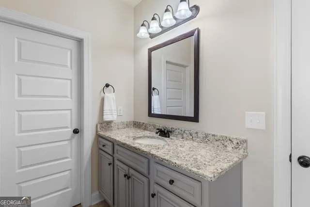 a bathroom with a sink vanity and a mirror