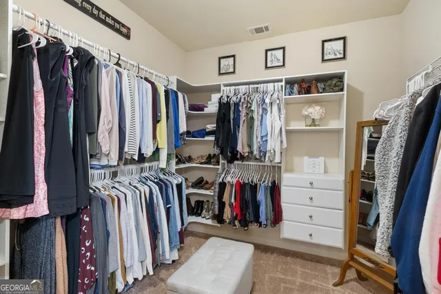 a view of walk in closet with clothes