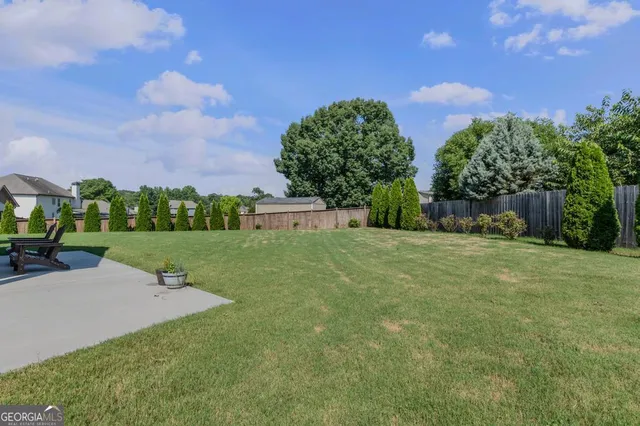 an aerial view of a house with garden space and a lake view