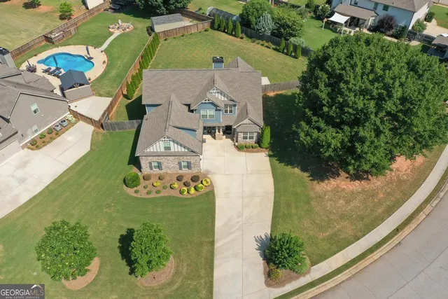 an aerial view of a house with a swimming pool