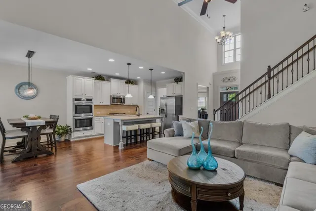 a living room with furniture kitchen view and a dining table