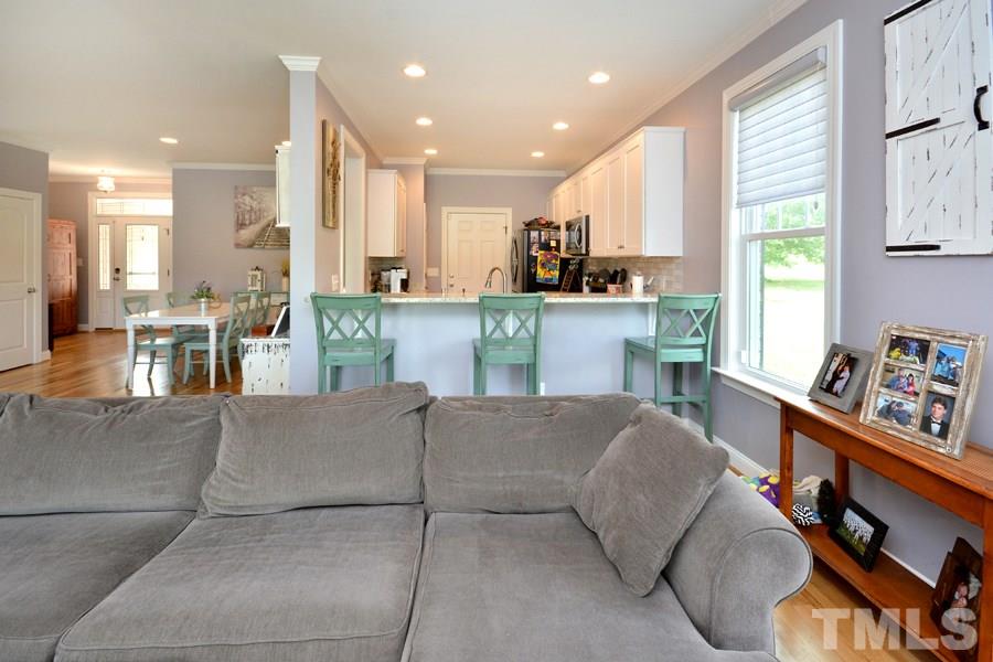 41 South Old Lantern Road Timberlake, NC 27583 - Photo 14 of 25 a living room with furniture a kitchen view and a large window
