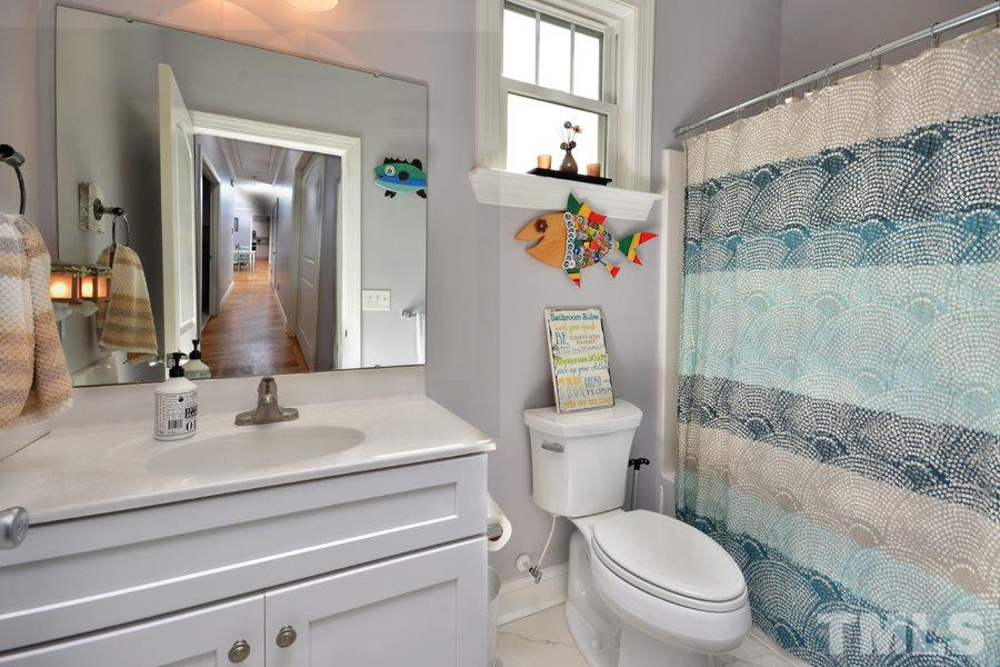 41 South Old Lantern Road Timberlake, NC 27583 - Photo 21 of 25 a bathroom with a sink toilet and shower